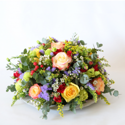 Statice, wax flower, rose, solidago, eustoma, spray rose, hypericum & green.