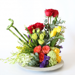 Tulip, rose, snow ball, solidago, orchid, statice, bamboo, wax flower & eustoma. 